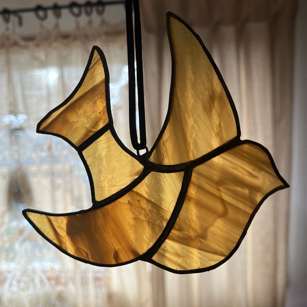 Vintage stained amber glass window dove